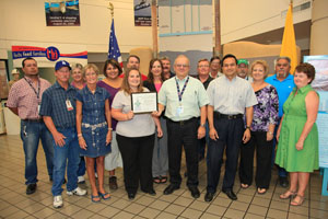 Department of Energy Carlsbad Field Office Deputy Manager Ed Ziemianski presents a WIPP team with the Green Zia Program Silver Level Award from the New Mexico Environment Department on Aug. 15, 2012 in recognition of environmental initiatives. Shown right of Ziemianski is Farok Sharif, president and general manager of URS Washington TRU Solutions LLC, the WIPP management and operating contractor.